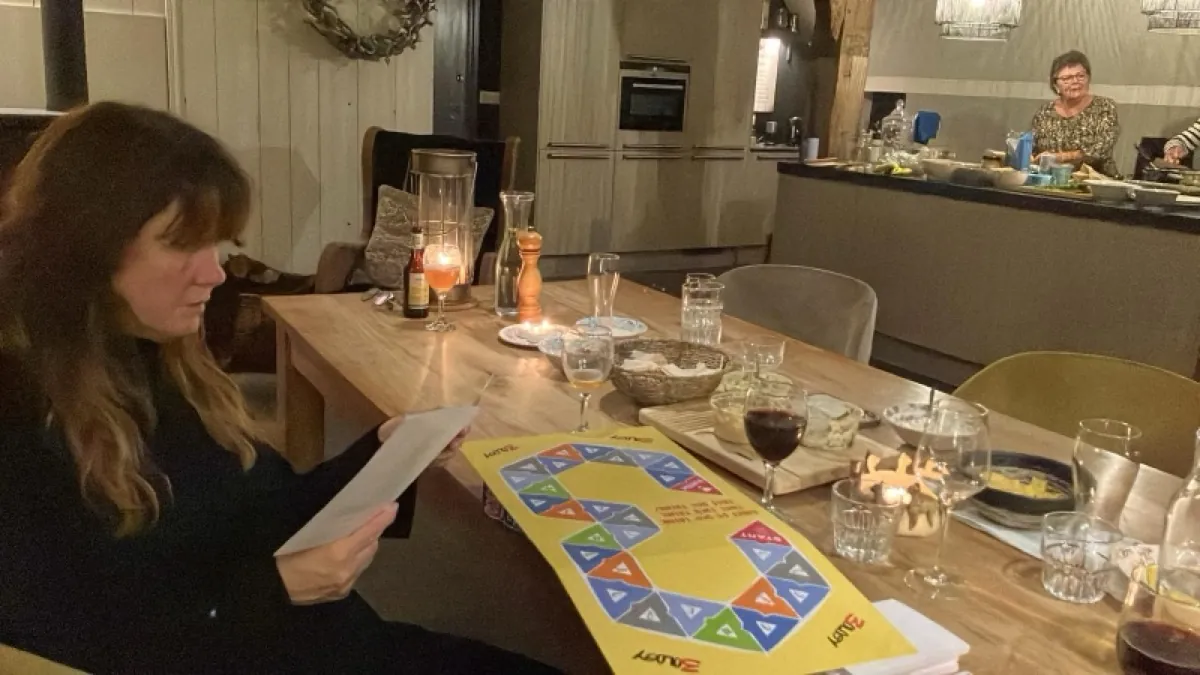 Players deliberating over their Top 3 by candlelight
